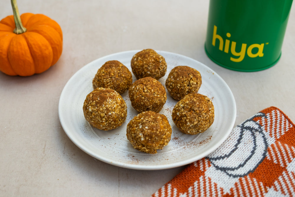 Five ingredients, no baking, and easy enough for kids to help make. Oats, pumpkin purée, nut butter, and Hiya Vanilla Greens roll into snackable balls that hold their shape in the fridge and are ready to grab throughout the week.