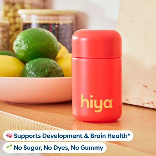 Red Hiya vitamin tablet bottle for kids, supports development & brain health, no sugar or dyes