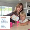 Mom giving child vitamin tablet from pink bottle, happy family moment