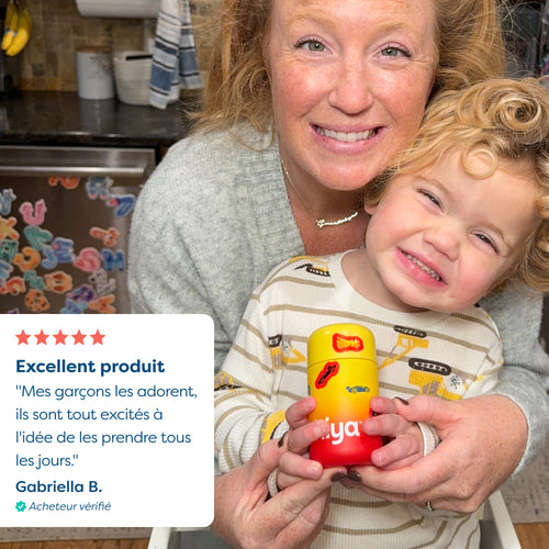 Mom and child holding colorful vitamin tablet bottle in kitchen, happy family moment