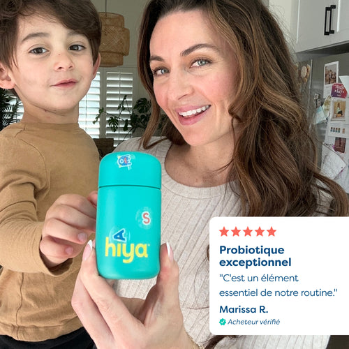 Mom and child holding kids' vitamin tablet bottle, smiling in kitchen with 5-star review