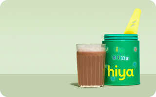 Chocolate kids super nutrient drink with green Hiya container and yellow spoon, healthy childhood nutrition