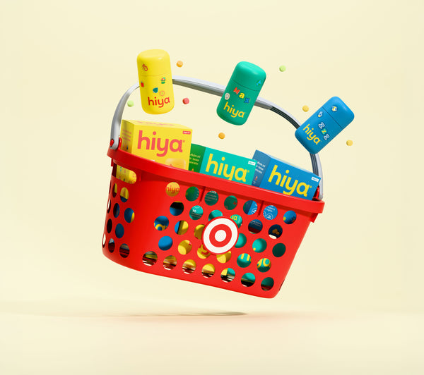 Red Target basket filled with colorful Hiya kids' vitamin bottles and boxes, showcasing essential super nutrients for children’s health.