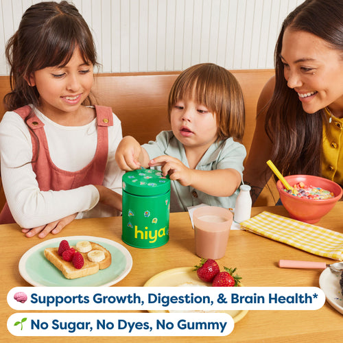 Kids enjoying healthy breakfast with vitamin tablets from green Hiya container, no sugar or dyes