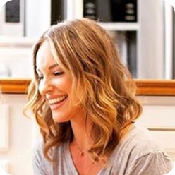 Smiling woman in kitchen, promoting kids' health and nutrition