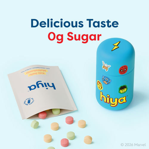 Kids daily multivitamin tablets in colorful shapes with superhero-themed storage jar, sugar-free formula