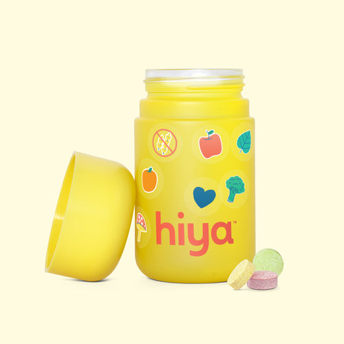 Kids vitamin tablets in a yellow bottle with fruit and veggie icons, gluten-free, for healthy children's nutrition