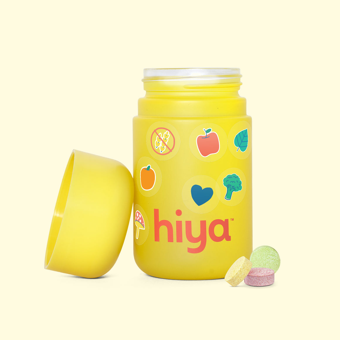 Kids vitamin tablets in a yellow bottle with fruit and veggie icons, gluten-free, for healthy children's nutrition