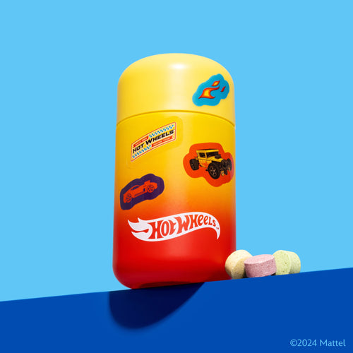 Hot Wheels themed vitamin tablets in colorful bottle for kids, featuring racing cars and flame logo on bright blue background
