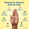 Hand holding kids' vitamin tablet with science-backed nutrients like Vitamin C, D, B12, Zinc for immune, sleep, growth