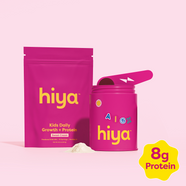 Kids daily growth + protein powder and vitamin tablets in pink Hiya containers on soft pink background
