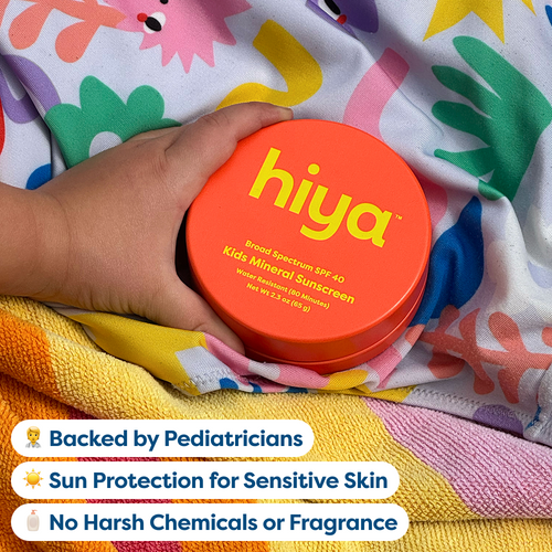 Child holding Hiya Kids Mineral Sunscreen SPF 40, water-resistant, gentle for sensitive skin, no harsh chemicals