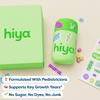 Hiya teen essential vitamins in green bottle with colorful stickers, sugar-free chewables, and pediatrician-formulated label